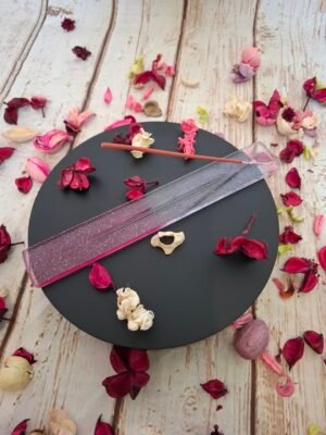 Porte-encens en résine rose translucide, décoré de motifs délicats et de paillettes, parfait pour un moment zen à la maison.