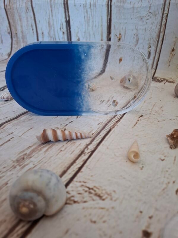 rangement-transparent-plateau-anniversaire-unique-006 Vide-poche fait main avec couleur bleue profonde et transparence scintillante – Décoré de coquillages et paillettes, il évoque un mini-océan miniature et poétique.