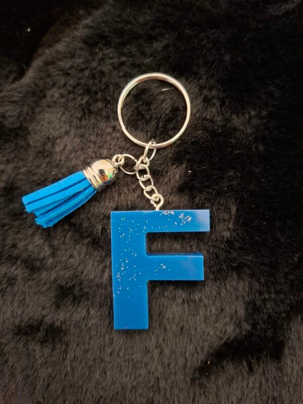 bapteme-argente-epoxy-faitmain-expedition-souvenir-initiales-colis-personnalisation-004 Charmant porte-clés orné d’un pompon tout doux, apportant mouvement et légèreté à chaque geste, idéal pour embellir clés, sacs ou trousses avec style.